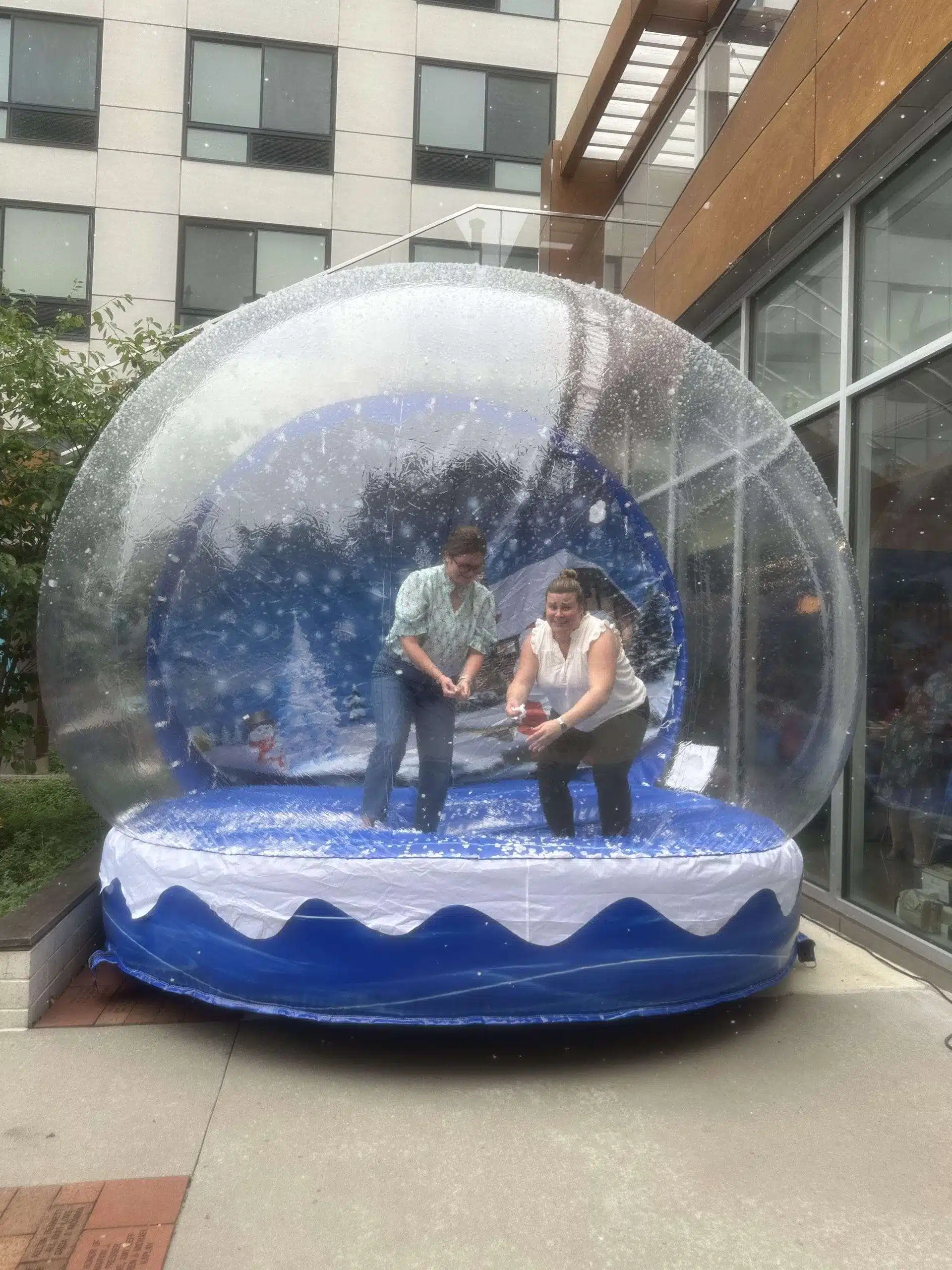 Guests inside the giant inflatable human snow globe with falling snow