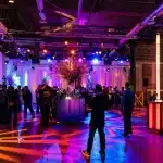 a vibrant, modern photo booth set up in a stylish philadelphia event space, featuring dynamic lighting and customizable backdrops, surrounded by guests joyfully capturing memories.