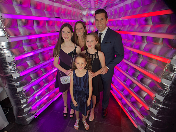 Vogue Photo Booth 5 Family portrait inside the Vogue Booth with vivid magenta lighting