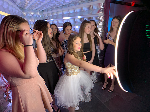 Vogue Photo Booth 4 Guests interacting with the Vogue Booth camera and ring light